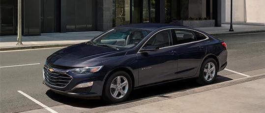 A blue 2023 Chevy Malibu parked on a street